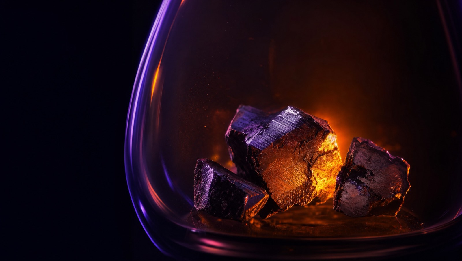 Recovered metal fragments in glass under amber rim light